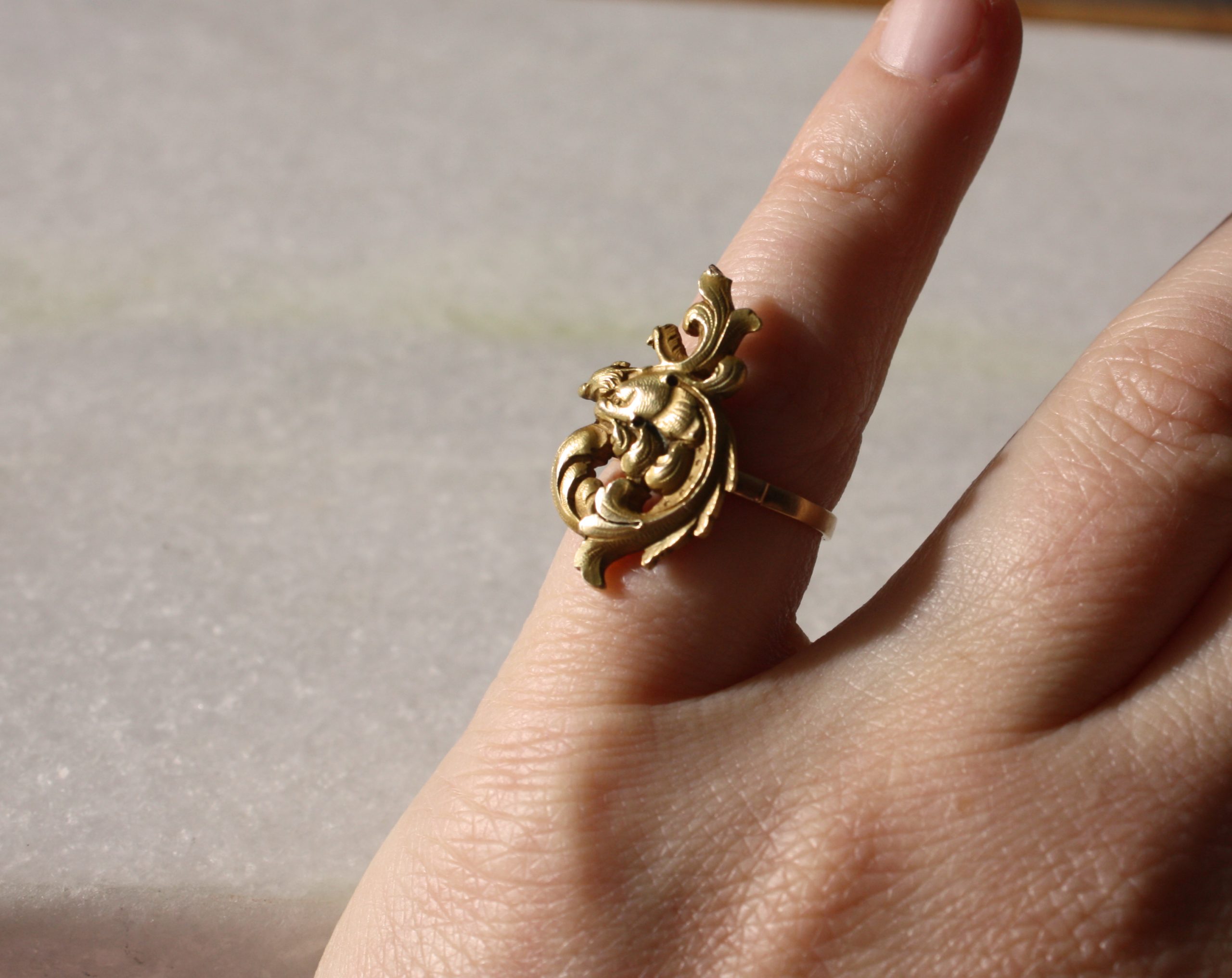 Unique piece, a fantastic antique french chimera ring in 18K gold, in Art Nouveau, under the sun light.